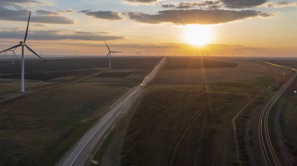 Energy. Wind turbines at dusk at sunset, aerial view