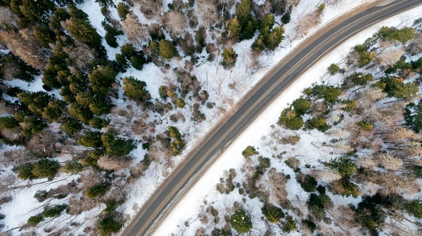 stock image Winter road in the mountains, from the air, top view, Aerial view of a curvy road in winter