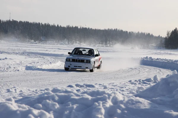 TAHKO, FINLAND - FEBRUARY 23, 2010: A racing car BMW in motion at the winter rally in Tahko, Finland — Stock Image TAHKO, FINLAND - FEBRUARY 23, 2010: A racing car BMW in motion at the winter rally in Tahko, Finland Stock Photo