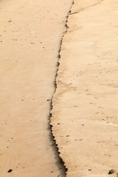 Våt sand vid havet — Stockfoto