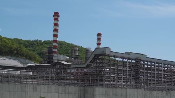 Graue Betonkarkasse einer verlassenen Fabrik mit Schornsteinen — Stockvideo