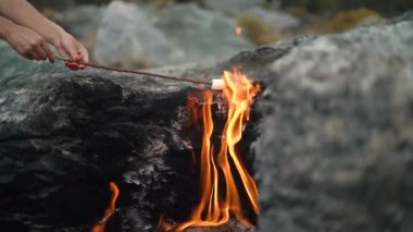 Kadın eşsiz Yanartas dağ ateşinde marşmelov kızarttı
