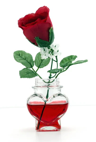 A Rose in a heart shaped bottle — Stock Photo, Image