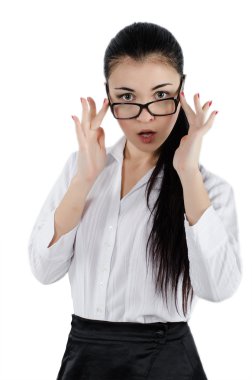 Surprised young woman holding eyeglasses and taking a closer look. White background. Studio shot