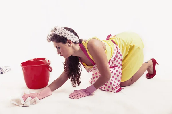 Pretty housemaid with cloth and bucket cleaning the floor — Stockfoto