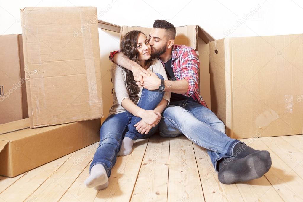 young couple relaxes and kisses after the move