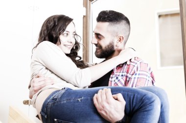 genç adam kız arkadaşı kollarında taşıdıktan sonra holding