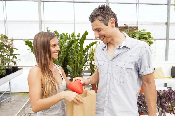 Couple in love - boyfriend gives the symbol of his heart — Stock Photo, Image