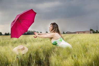 buğday kulak bir alanda şemsiye ile güzel kadın