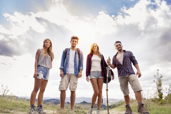 Grupo de jovens caminhantes caminhando em direção ao horizonte sobre a montanha — Fotografia de Stock