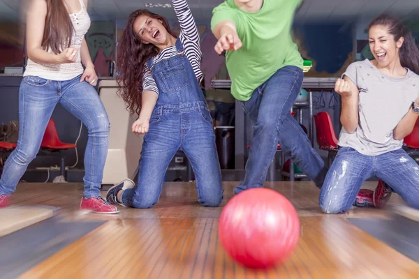 Groupe de jeunes adultes s'amusant à jouer sur la piste de bowling — Photo