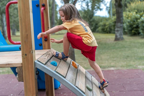 Cute Little Girl Have Fun Climbing Wooden Structure Playground — Fotografia de Stock