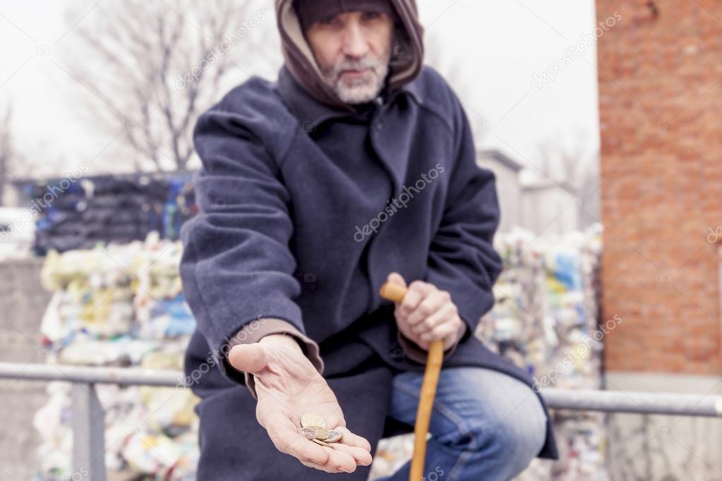 homeless asks charity in landfill