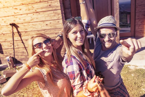 Grupa przyjaciół uśmiechający się biorąc zabawny selfie z inteligentny telefon — Zdjęcie stockowe