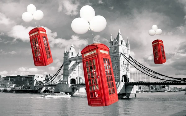 English phone booths flying above the tower bridge — Stock Photo, Image