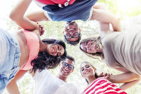 Gruppe lächelnder Freunde im Kreis - Ansicht von unten — Stockfoto