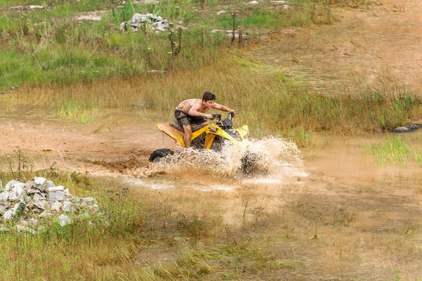 Off road on 4x4 quad bike through mud puddle — Stock Photo, Image