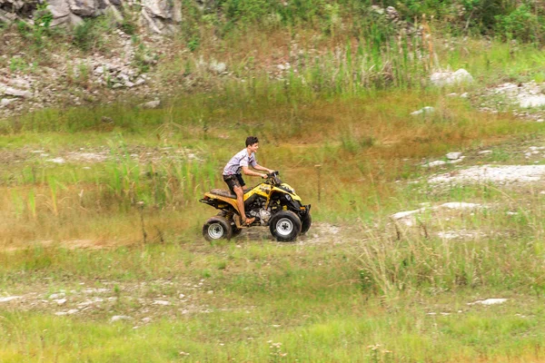 Off road on quad bike rally over mud puddle — Stock Photo, Image