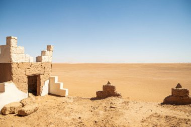 Kırsal bir teras, Iriki Gölü 'nün (Fas) büyüklüğünü algılayarak ufka bakmamızı sağlıyor. Fas 'ın çöl bölgelerinde çok tipik olarak kerpiç (çamur) yapımından yapılmıştır. Kahverengi ve koyu