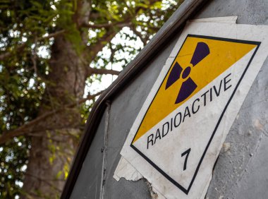 Radyasyon taşıma etiketi sınıf 7 etiketi alüminyum kamyon konteynırındaki eski çıkartmaya yapıştırılmış.