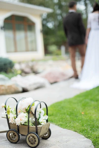 Close-up de flores brancas em carruagem contra de casal desfocado — Fotografia de Stock