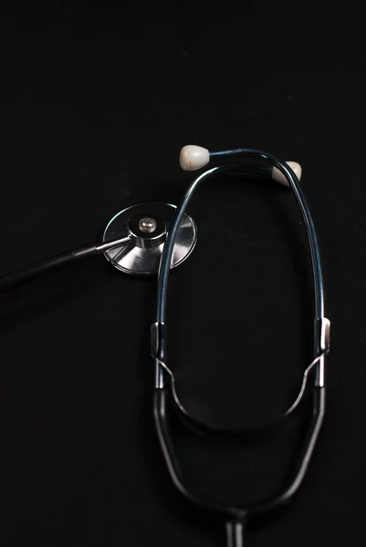 Stethoscope reflection on black background — Stock Photo, Image