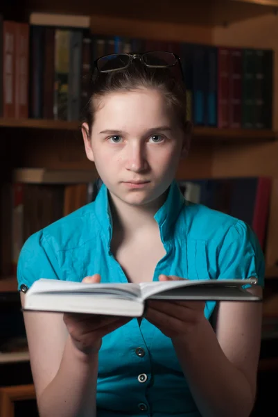 Young girl in glasses reading a book — Stock Photo, Image