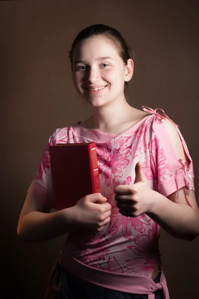 Young beautiful girl with a red book — Stock Photo, Image