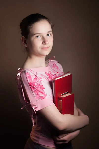 Young beautiful girl with a red book — Stock Photo, Image