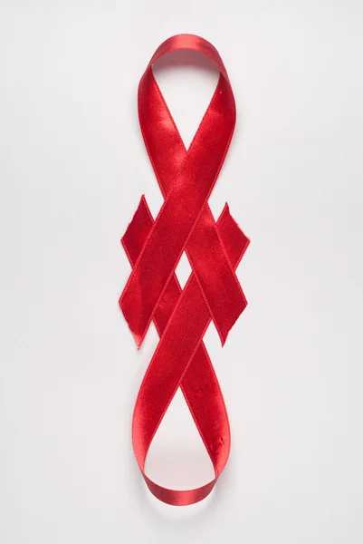 Shiny red satin ribbon on white background — Stock Photo, Image