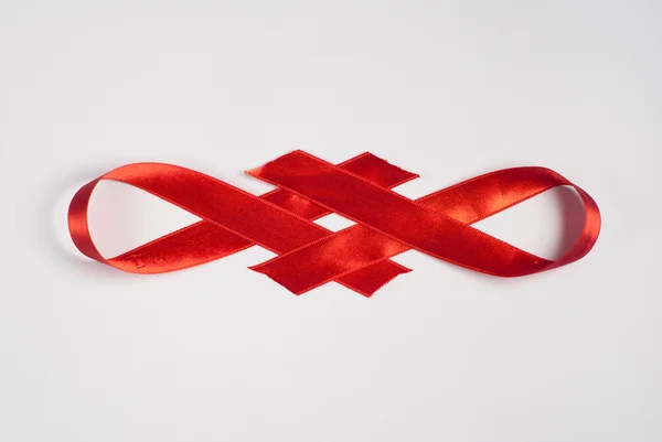 Shiny red satin ribbon on white background — Stock Photo, Image