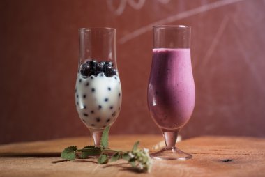 milkshake of blueberries, two glasses on a wooden table, clipart