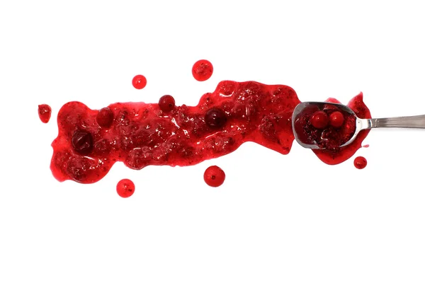 Splashes and spilled cranberry sauce with a spoon — Stock Photo, Image