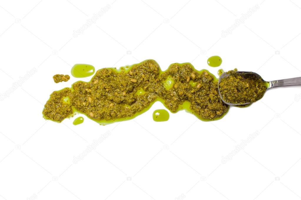 pesto and spoon isolated on white background