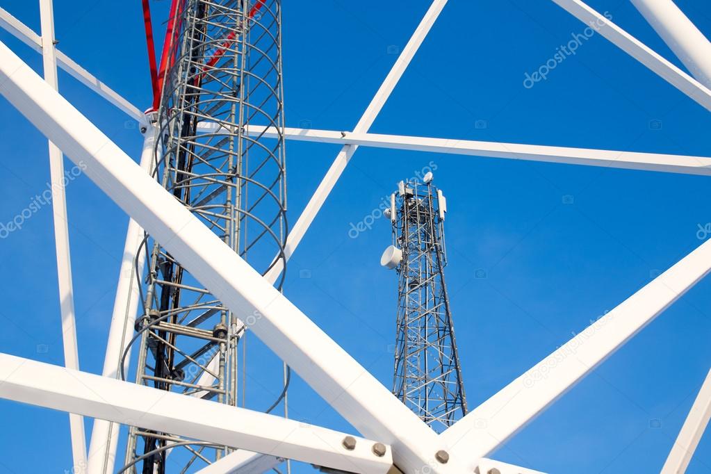 metal construction telecommunications tower against a blue sky