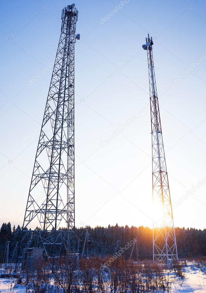 two telecommunications towers in a shot entirely