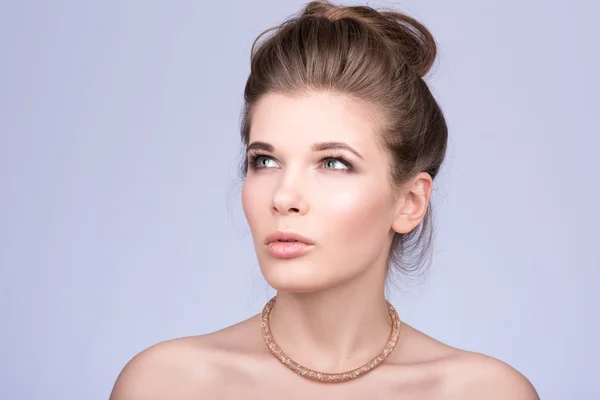 Portrait of beautiful young woman. Luxury accessory on your neck. Nude makeup Stock Picture