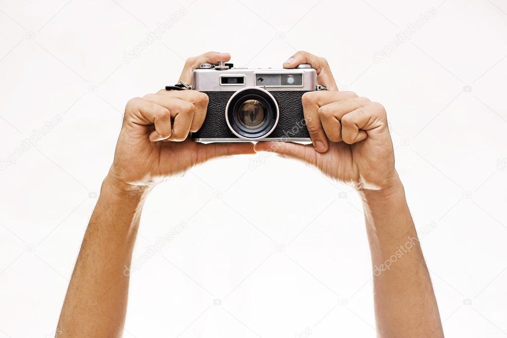 Hands Holding A Wintage Camera isolated on white 
