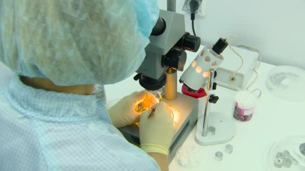 Scientist in the Mask in the Sterile Lab Working With Microscope on the Research. Closeup — Stock Video