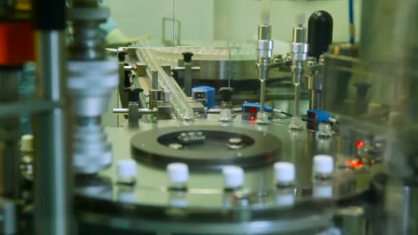 Production of Pharmaceuticals. Automated Production Line Machine Conveyor at a Factory Screw Cap on Bottles. Pharmaceutical Industry — Stock Video