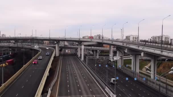 Large multi-lane pathway in the city. Cars are moving across the bridge. Road connection within the city. Aerial view — Stock Video