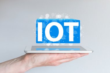 IOT (internet of things) concept and information technology background. Hand holding modern smart phone