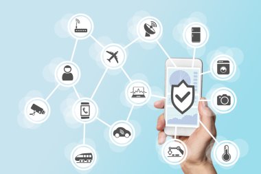 Internet of things security concept with hand holding modern smart phone to control intruders into a network of objects