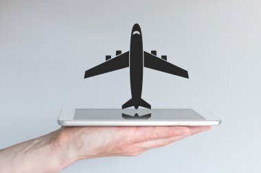 Online flight booking concept with smart phone or tablet.