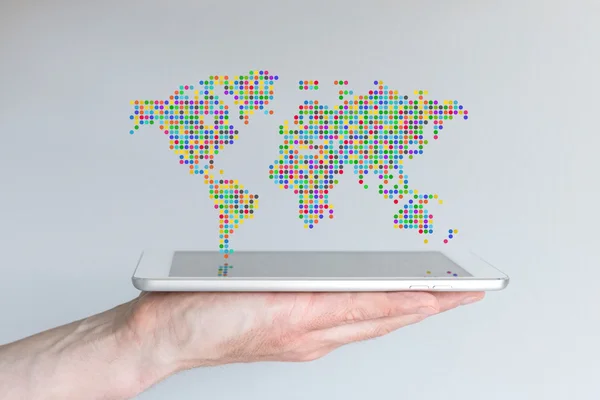 World map floating above a modern smart phone or tablet — ストック写真