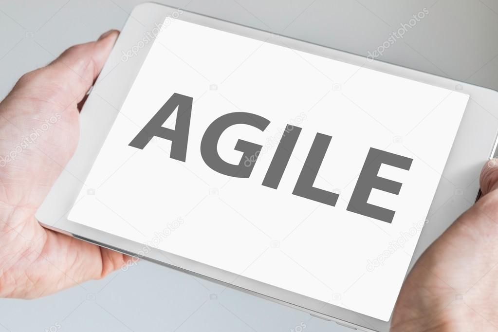 Agile text displayed on touchscreen of modern tablet or smart device. Concept of modern software development methodology for smartphones.