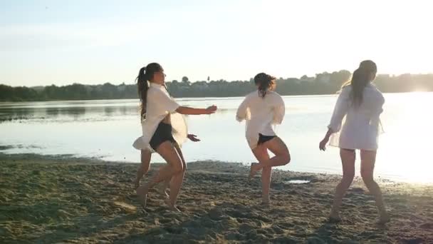 Actuación de baile de cuatro chicas en la playa de arena cerca del lago al amanecer — Vídeos de Stock