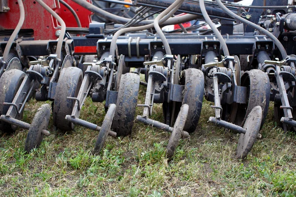 Mecanismo moderno tractor rojo de tecnología de cerca en un campo agrícola — Foto de Stock