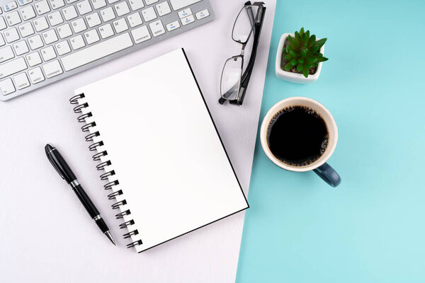 Blank notepad with cup of coffee and computer keyboard flat lay