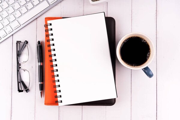 Blank notepad with cup of coffee and computer keyboard flat lay